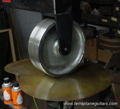 dsc00252sm.jpg - An English Wheel is used to stretch and planish out all hammer marks that were created in the roughing out process. By using different radius anvils the entire back can be blended into a beautiful smooth surface.